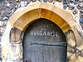 Commit No Nuisance sign on clock tower door