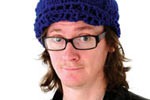 Ed Byrne demonstrates the wearing of a woolly hat.