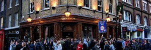 People smoking outside the John Snow Pub