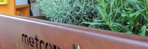 The Metropollen planter and seat, with bee hive and bat box in the background