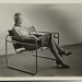 Erich Consemüller, Lis Beyer or Ise Gropius sitting on the B3 club chair by Marcel Breuer and wearing a mask by Oskar Schlemmer and dress fabric by Lis Beyer, c. 1927