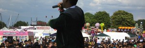 East London Mela performance with businesses & stalls background