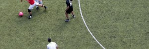 Footballers play on a pitch in Camden