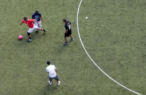 Footballers play on a pitch in Camden
