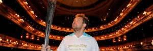 Actor Eddie Marsan holds the Paralympic Flame inside the Royal Opera House in London.