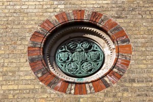 A foundation plaque showing the shields of the various civic bodies who financed the project.